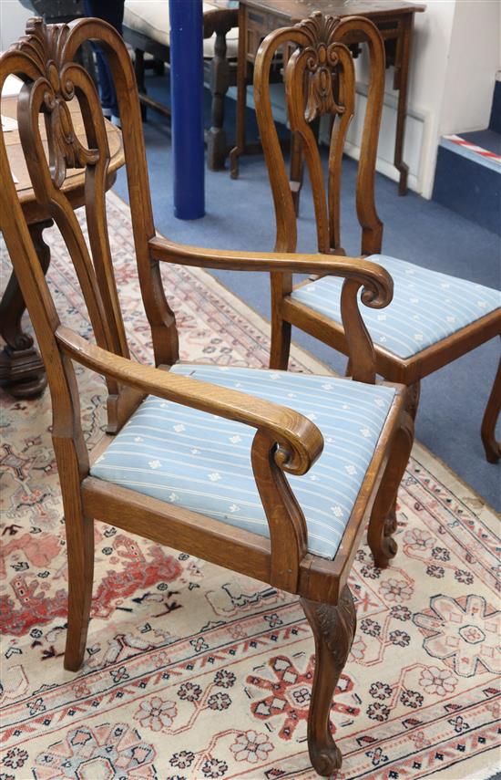 A set of six 18th century style oak dining chairs, on carved cabriole legs (two with arms)